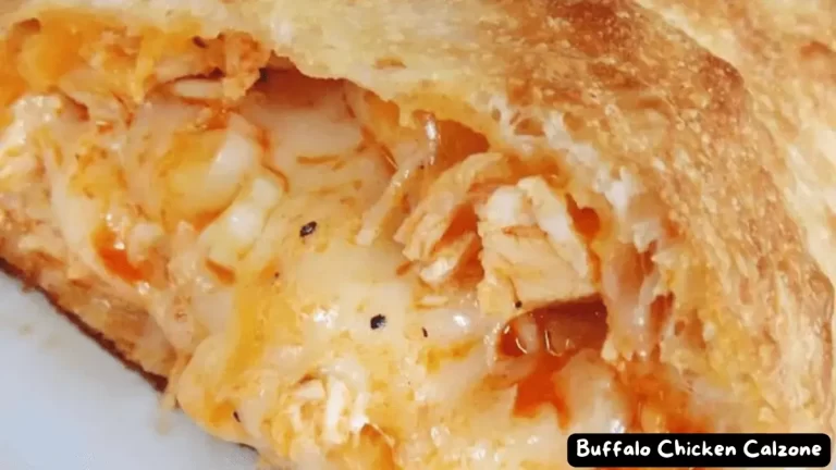 Close-up of a golden brown Buffalo Chicken Calzone with melted cheese oozing out.