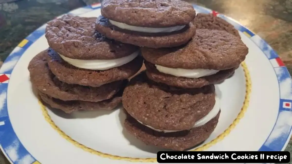 A plate of chocolate sandwich cookies with creamy white filling, stacked in a pyramid shape.