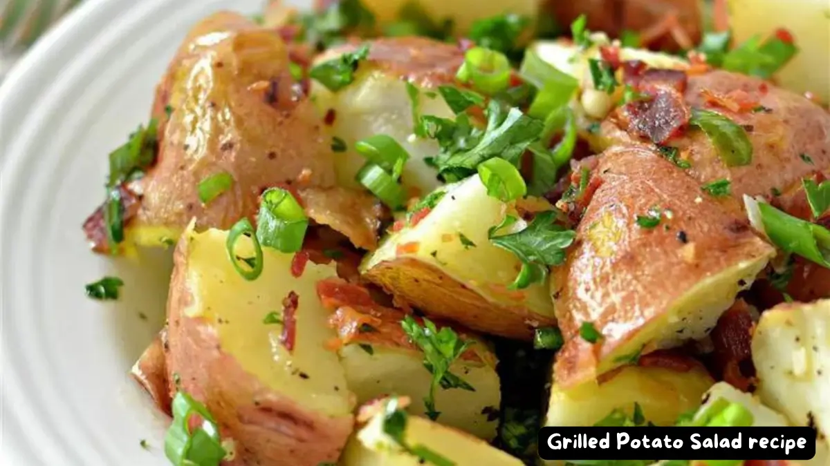 Close-up view of a grilled potato salad with chopped green onions and parsley.