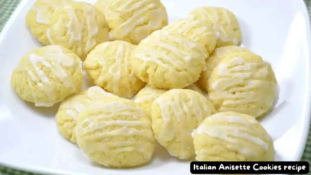 A plate of freshly baked Italian Anisette Cookies drizzled with glossy anise icing.