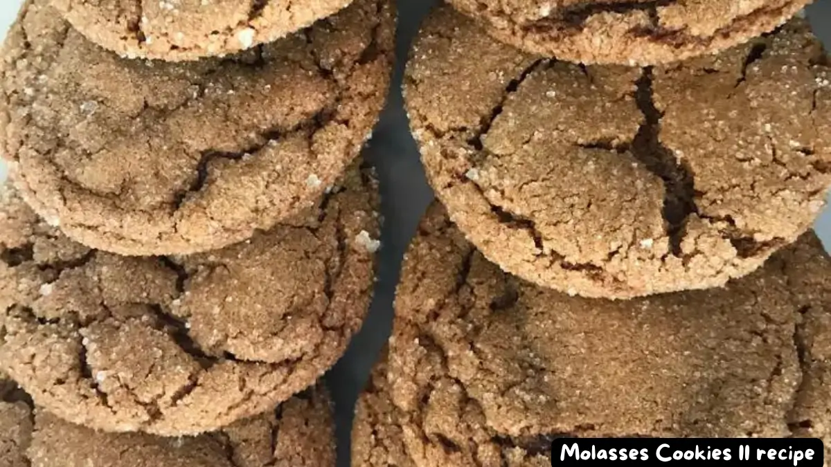 Close-up view of several stacked molasses cookies with crinkled tops and sugar coating.