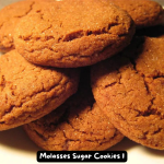 A stack of freshly baked Molasses Sugar Cookies on a plate