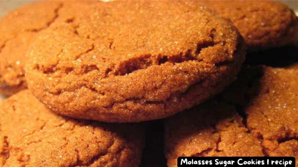 Close-up of Molasses Sugar Cookies with a golden brown color and a slightly cracked surface.