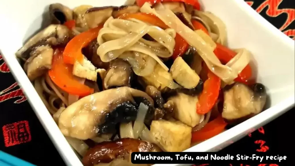 A bowl of Mushroom, Tofu, and Noodle Stir-Fry with vibrant vegetables.