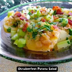 A bowl of traditional German Oktoberfest potato salad with bacon and parsley.