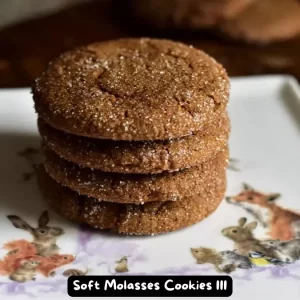 A batch of freshly baked Soft Molasses Cookies with a rich brown color and a slightly cracked surface.