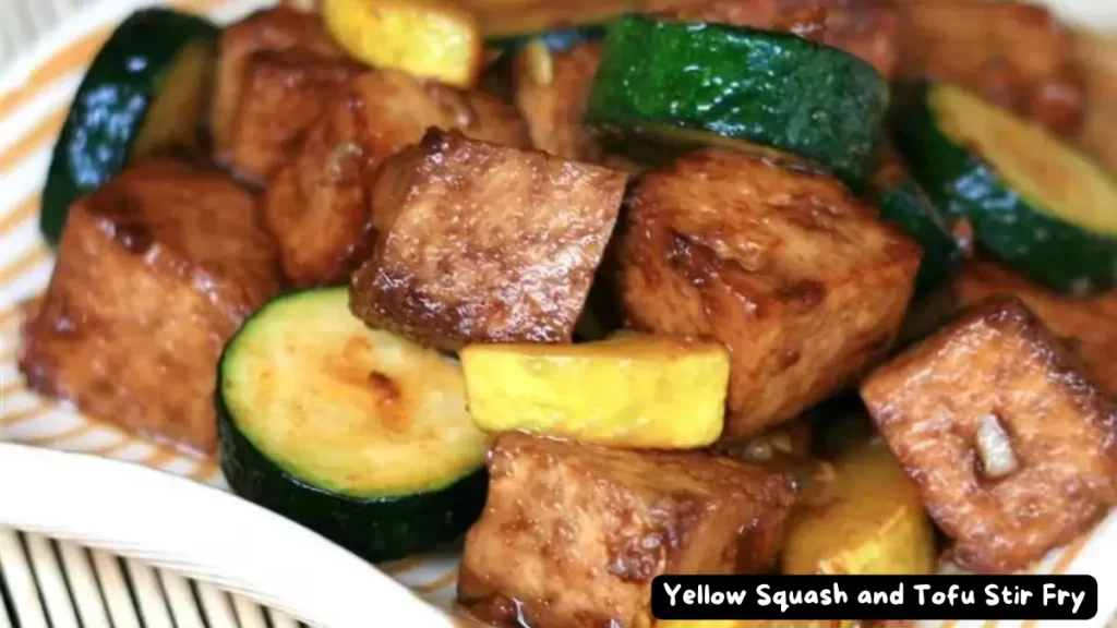 A vibrant stir fry with yellow squash, zucchini, and tofu, displayed in a bowl with the text "Yellow Squash and Tofu Stir Fry".