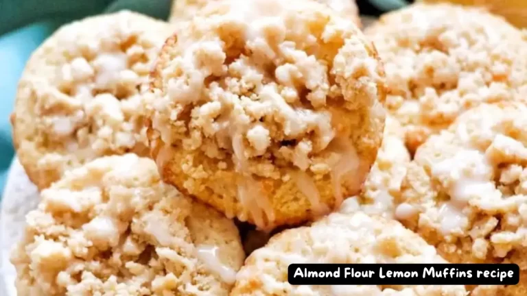 Close-up of freshly baked Almond Flour Lemon Muffins topped with a delightful crumble and lemon glaze.