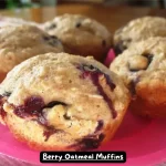 Freshly baked berry oatmeal muffins with a crispy oat topping.