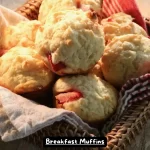 A plate of freshly baked breakfast muffins with blueberries.