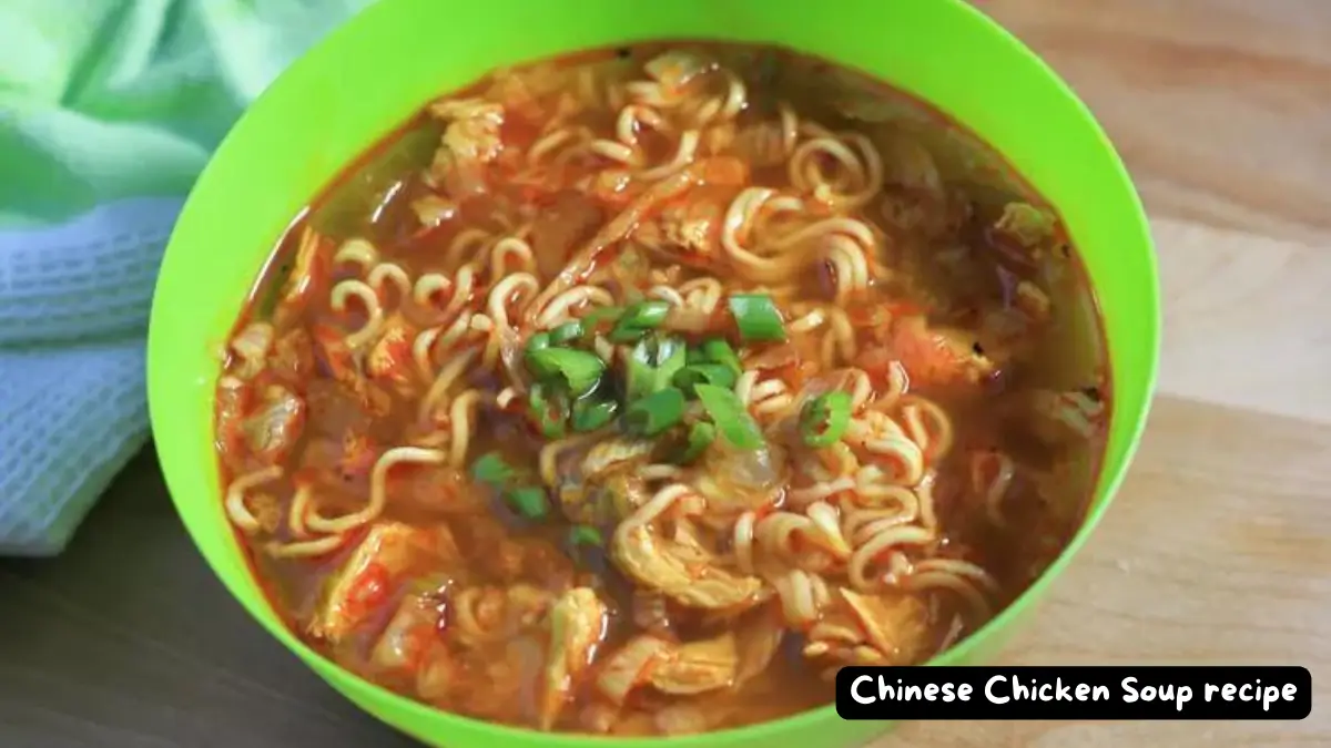 A vibrant green bowl filled with Chinese chicken soup and ramen noodles, garnished with fresh green onions.