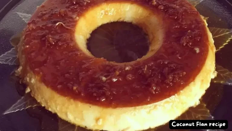 A close-up of a Coconut Flan with a caramel glaze, showcasing its smooth texture and golden hue.