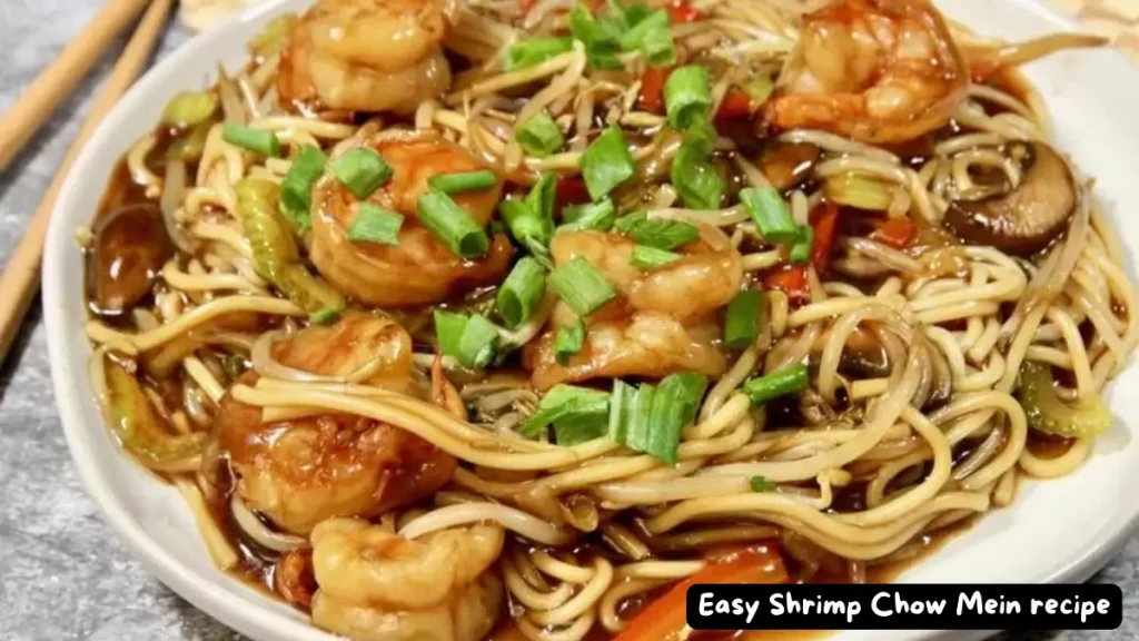 A close-up of a delicious serving of Easy Shrimp Chow Mein garnished with green onions.