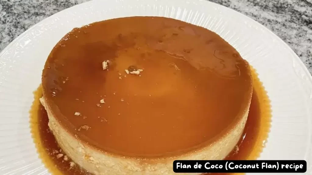 A perfectly baked Flan de Coco topped with a rich golden caramel sauce, served on a white plate.