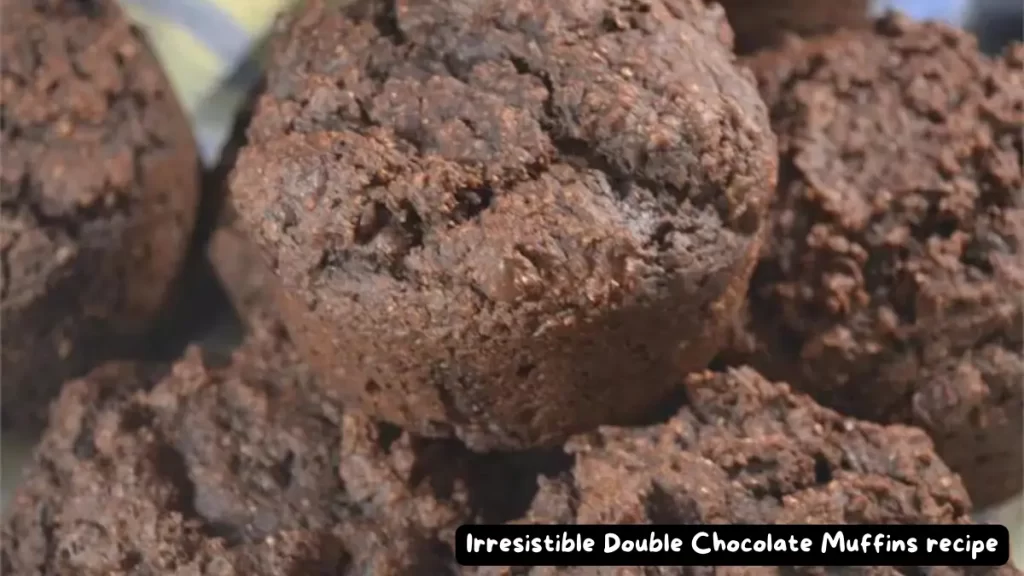 Close-up view of a batch of irresistible double chocolate muffins, showcasing their rich texture and decadent chocolate flavor.