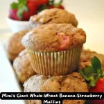 Freshly baked giant whole wheat banana strawberry muffins in a muffin tin