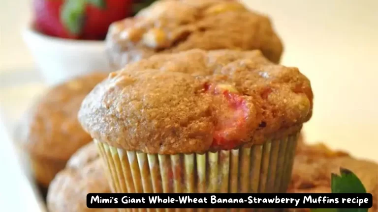 A close-up view of freshly baked Mimi's Giant Whole Wheat Banana Strawberry Muffins showcasing their moist texture and fruity goodness.