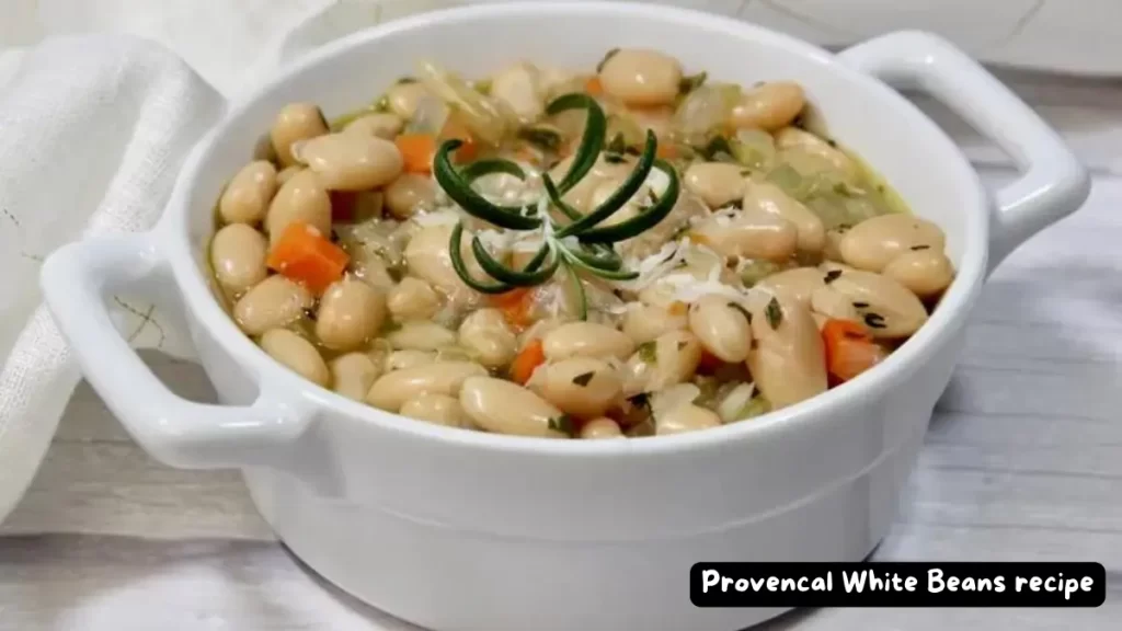 A bowl of Provencal White Beans garnished with fresh rosemary.