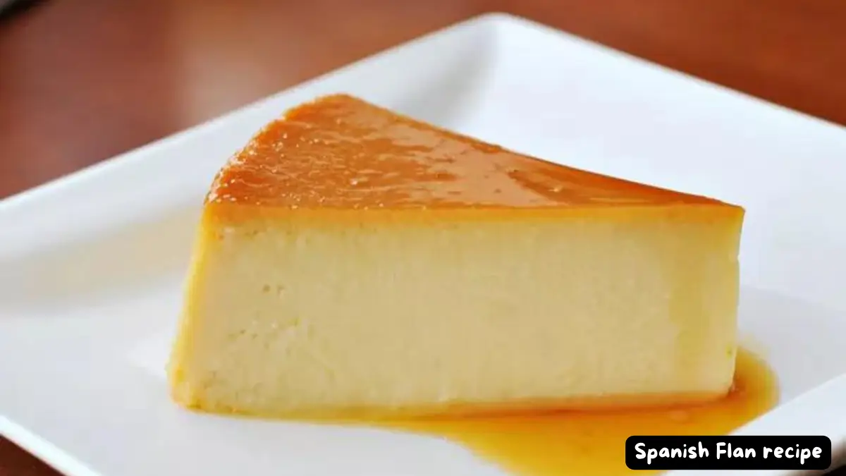 A slice of classic Spanish flan on a white plate with golden caramel sauce.