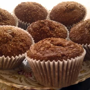 Banana and cinnamon muffins cooling on a wire rack with a crunchy cinnamon-sugar topping