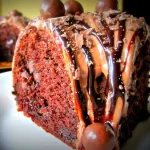 A decadent Death By Chocolate Cake topped with rich chocolate cream cheese frosting and chocolate shavings.