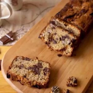 A slice of leftover banana, honeycomb, and chocolate cake on a plate.