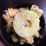 Tropical S'Mack and Cheese with golden brown top and pineapple rings in a baking dish.